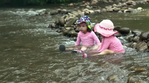 Toddlers playing in riverbed 03 Stock Footage 43386592
