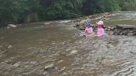 Toddlers playing in riverbed 04 Video stock 43386624