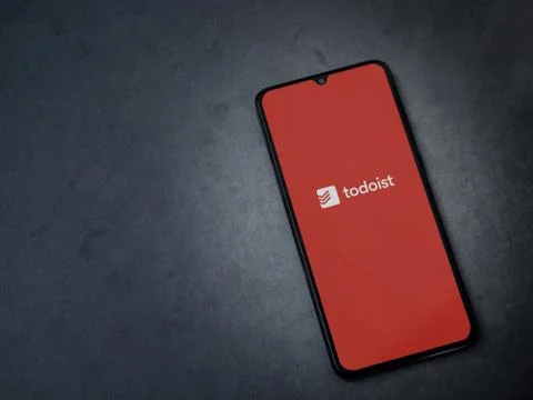 Todoist app launch screen with logo on the display of a black mobile smartpho Stock-Fotos