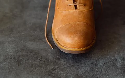 Toe boot. Comfortable fashionable leather shoe or boot on grey background. Stock Photos