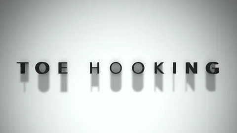 Toe hooking title matte black writing over a white background Stock Footage 301837795