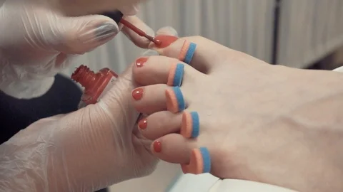 Toe nails covered with polish Stock Footage 87825359