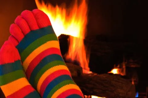 Toe socks by fireplace Stock Photos