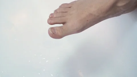 Toenails close up. Man cutting toenails with scissors on bathtub. Male cut toena Stock Footage 99728754