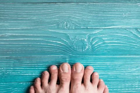 Toes on a background of blue board Stock Photos