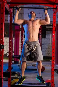 Toes to bar man pull-ups 2 bars workout Stock Photos
