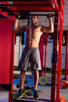 Toes to bar man pull-ups 2 bars workout Stock Photos