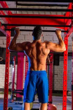 Toes to bar man pull-ups 2 bars workout Stock Photos