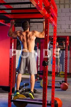 Toes to bar man pull-ups 2 bars workout Stock Photos