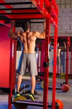 Toes to bar man pull-ups 2 bars workout Stock Photos