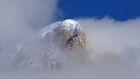 Tofane mountain after a snowfall, clouds are parcially covering the view Stock Footage 129595871