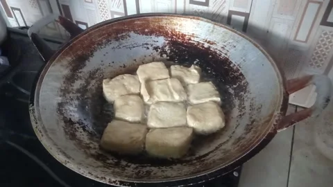 Tofu is being fried in a frying pan Stock Footage 212196378