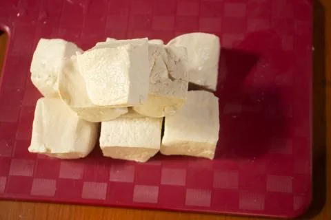 Tofu placed on a red plastic table Stock Photos