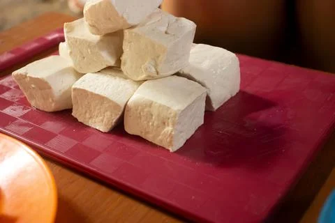 Tofu placed on a red plastic table Stock Photos