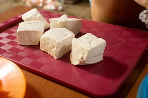 Tofu placed on a red plastic table Foto stock