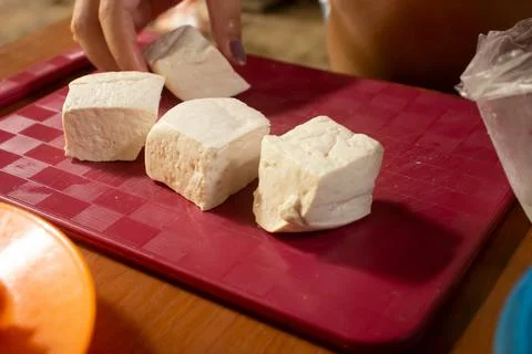 Tofu placed on a red plastic table Foto stock