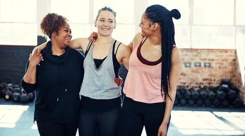 Together we can make this trough. three cheerful young women having a Stock Photos