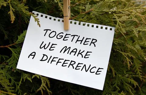 TOGETHER WE MAKE A DIFFERENCE - words on white paper with clothespin on a g.. Stock Photos