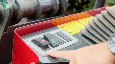 Toggle on and off lights and parking brake on mini tractor Stock Footage 221586005