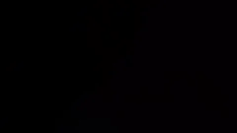 Toggle full-screen purple and white bokeh light on and off in black Stock Footage 315318319