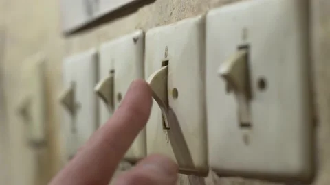 Toggle old vintage plastic switch on an old abandoned wall with finger Stock Footage 233566623