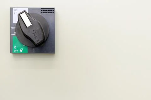 Toggle switch on the white wall. Operation ON-OFF switch Stock Photos