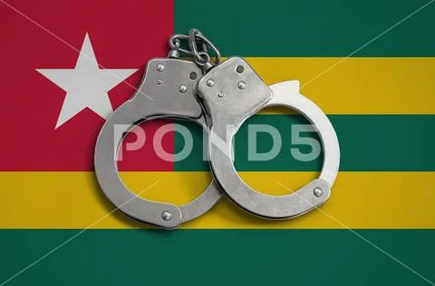 Togo flag and police handcuffs. The concept of observance of the law in the Stock Photos