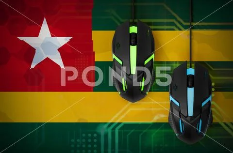 Togo flag and two mice with backlight. Online cooperative games. Cyber sport Stock Photos