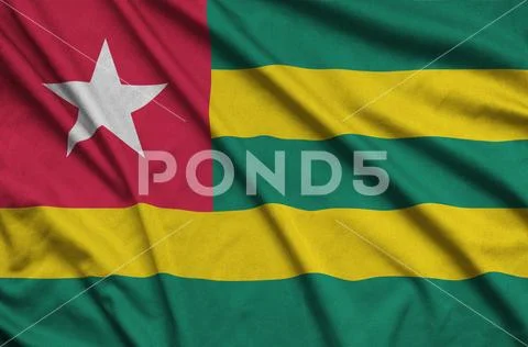 Togo flag is depicted on a sports cloth fabric with many folds. Sport team b Stock Photos