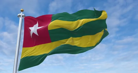 Togo flag with flagpole waving in rolling clouds looping, 4K Perfect Loop Stock Footage 280245562