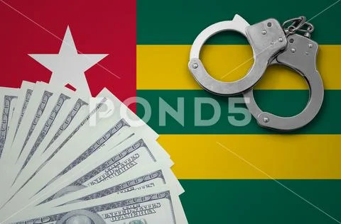 Togo flag with handcuffs and a bundle of dollars. The concept of illegal ban Stock Photos