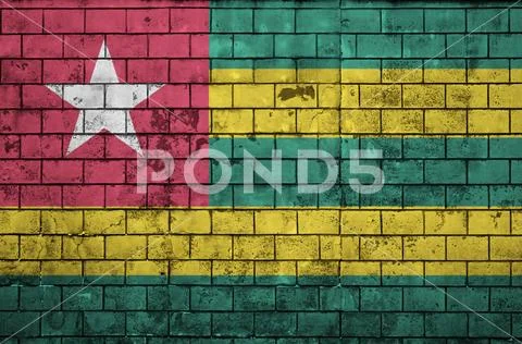 Togo flag is painted onto an old brick wall Stock Photos