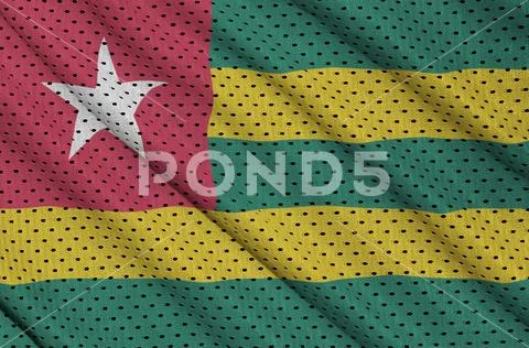 Togo flag printed on a polyester nylon sportswear mesh fabric wi Stock Photos