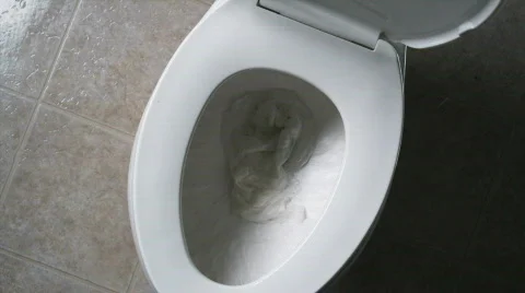Toilet paper flushing down the toilet Stock Footage