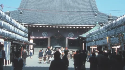 Tokyo - 1977: Visitors discover Senso-ji Temple, swastika of Buddhist tradition Stock Footage 278721843