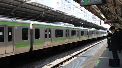 TOKYO - CIRCA MARCH 2013: Train arrives at a Tokyo subway station. Stock Footage 22663889