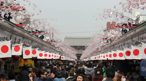 TOKYO - CIRCA MARCH 2013: Zoom out of crowded pathway at Senso-ji temple in Toky Stock Footage