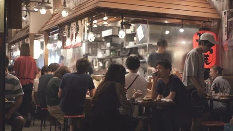 Tokyo Food District at Night Time - Group of Japanese People Talking. Stock Footage
