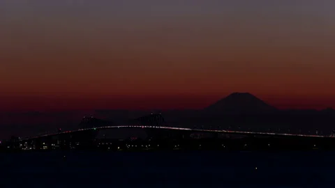 Tokyo Gate Bridge and Mount Fuji Shining with Car Tail Lights Stock Footage 327615260
