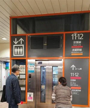 Tokyo, Japan on 14 Oct 2025. Older Man and Woman at Elevator Door in Subway.. Stock Photos