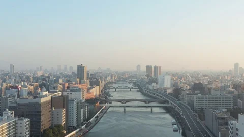 Tokyo, Japan. Sunrise over city skyline, aerial rise over Sumida River Stock Footage