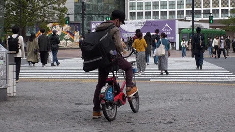 TOKYO, JAPAN : Uber Eats food delivery at the street. Stock Footage 129493225