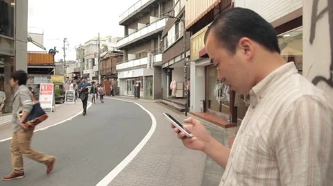 Tokyo man using mobile device on street Video stock 40516946