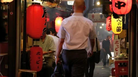 Tokyo office workers going home through a restaurant alley. Stock Footage 10719256