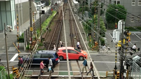 Tokyo - People and traffic at small railway crossing. 4K resolution. Shinjuku Stock Footage