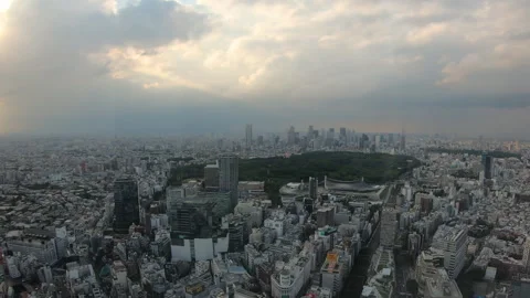 Tokyo Skyline Timelapse with Dramatic Sunlight Through Clouds Stock Footage 344364542