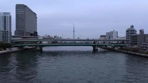 Tokyo Skytree Beyond Sumida River and Sumidagawa Bridge, Aerial 4K Stock Footage 346318881