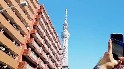 The Tokyo Skytree rises dramatically, framed by an upward perspective that Stock Footage 295662267
