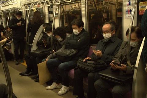 Tokyo train commuter wearing a mask Stock Photos