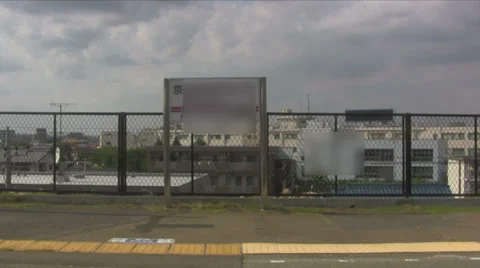 Tokyo train pulling out of a station in the countryside Video stock 39594503